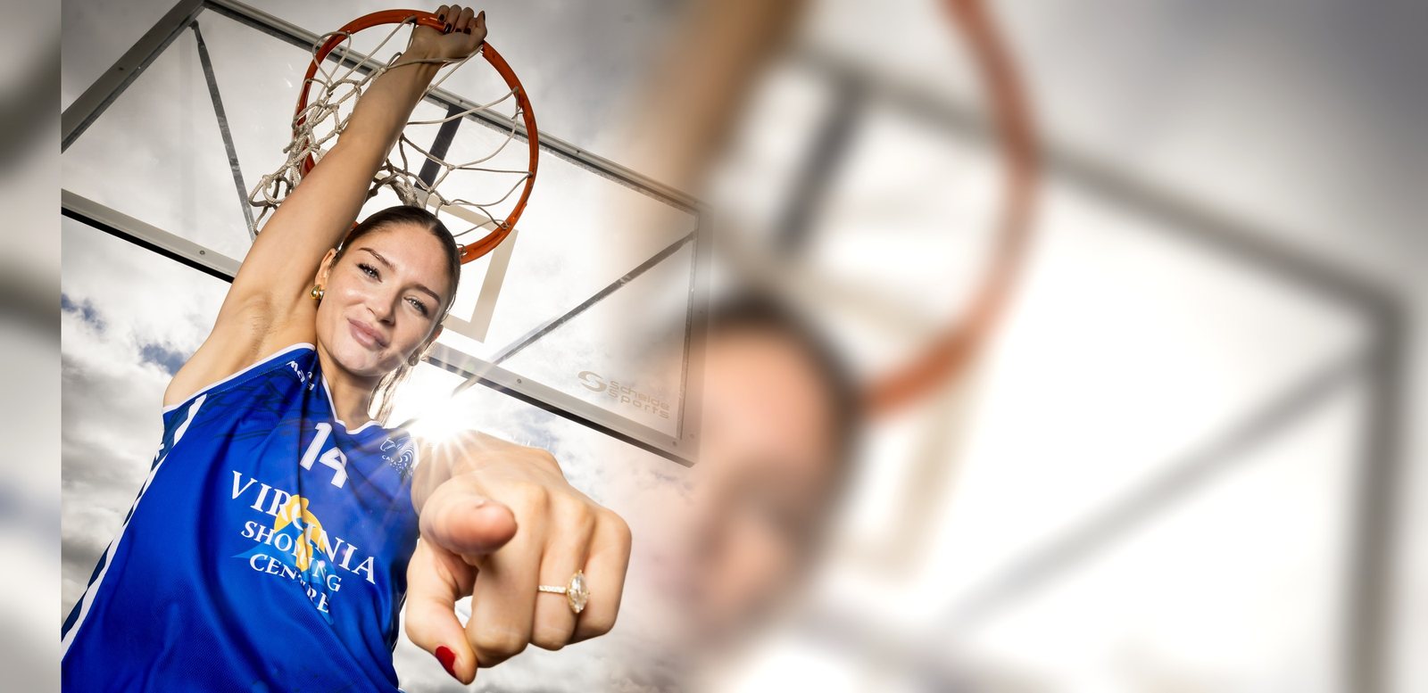 Cavan Eagles Women's Super League player hanging from the rim in the Virginia Shopping Centre jersey